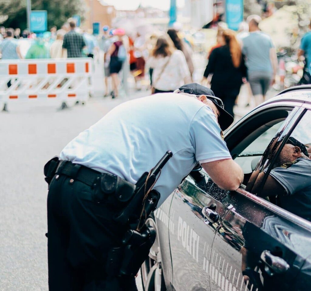 a police officer leaning into a police car
